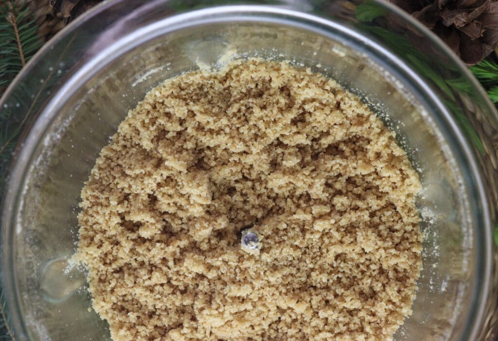 Adding butter to cookies for a cake base.